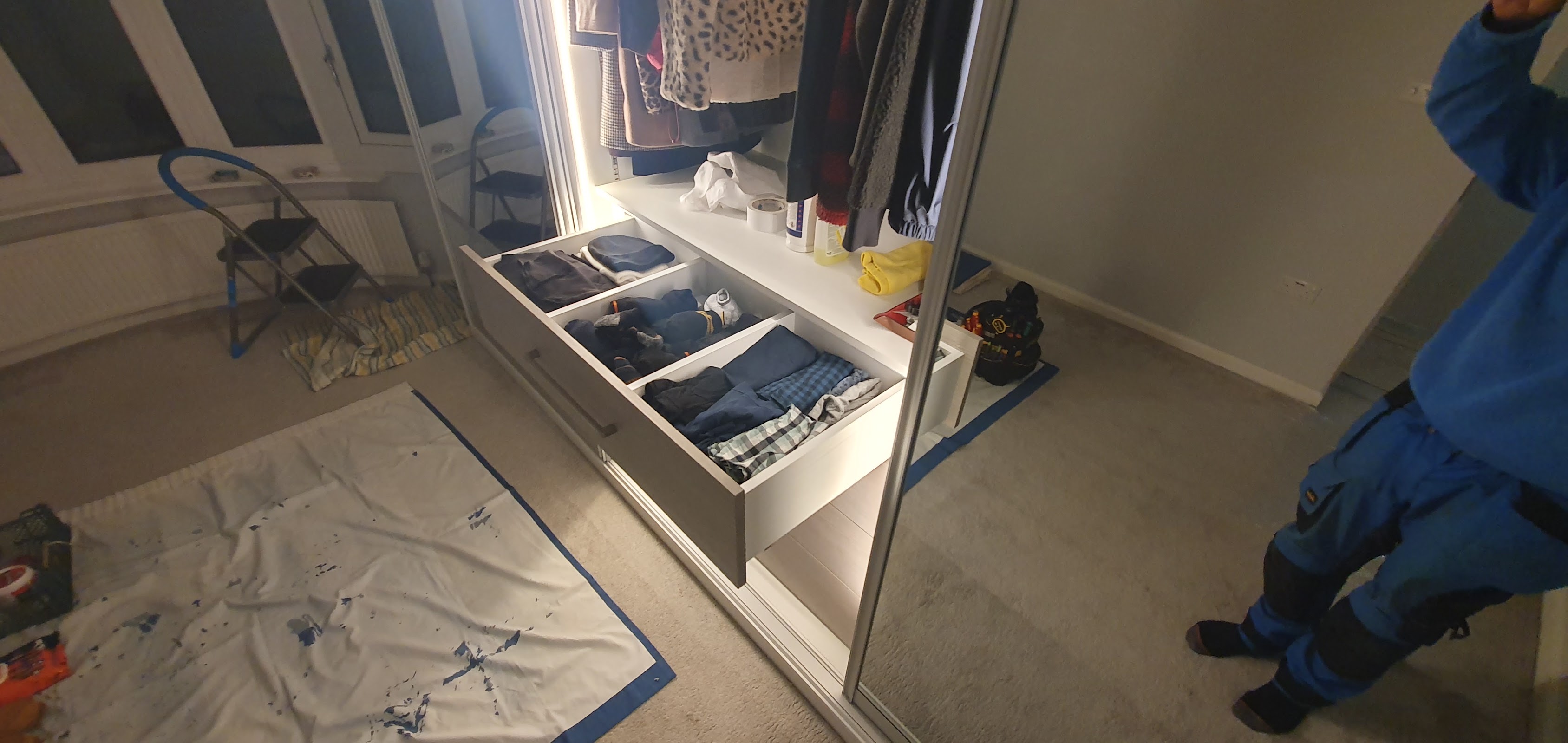 Our own installer fitting the drawers and internals of a sliding wardrobe — most installations are completed in a single day, floors protected throughout.